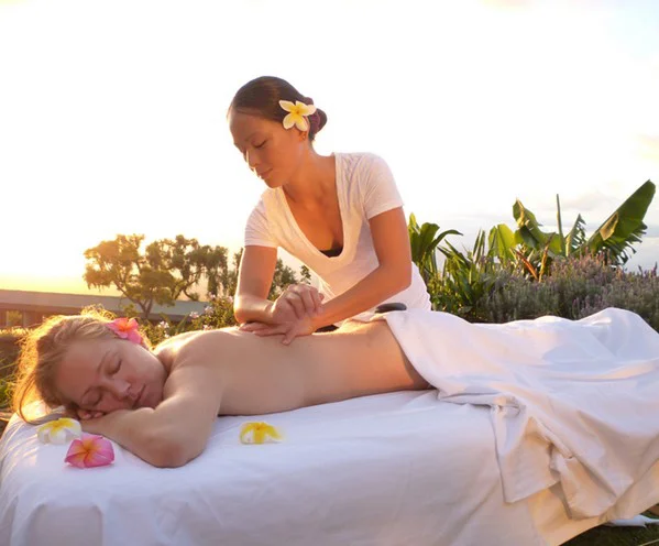 woman receiving Deep Lomi Lomi massage outdoors