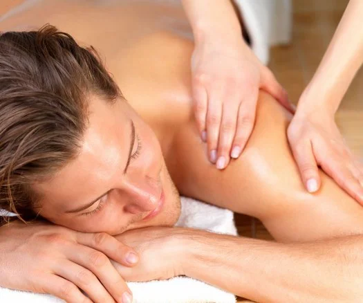 man recuperating from sports activity by getting a massage